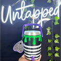 Untapped Innovations Beetlejuice themed insulated beverage cooler with black and white stripes and neon green slime.