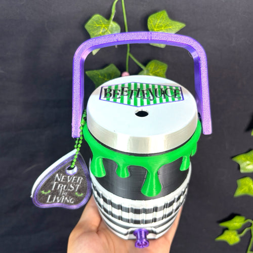 Untapped Innovations Beetlejuice themed beverage cooler with black and white stripes, neon green slime, and purple handle