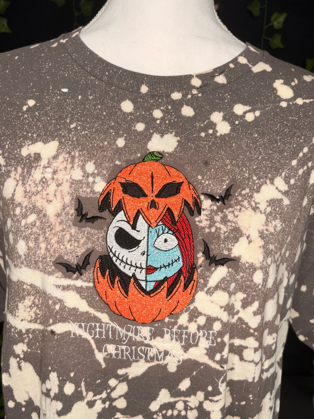 Untapped Innovations bleached t-shirt featuring embroidered Jack and Sally in a pumpkin with bats
