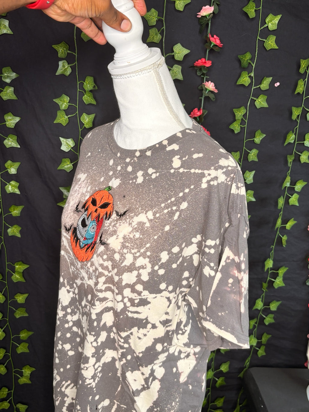 Untapped Innovations bleached t-shirt featuring embroidered Jack Skellington and Sally inside a pumpkin design.