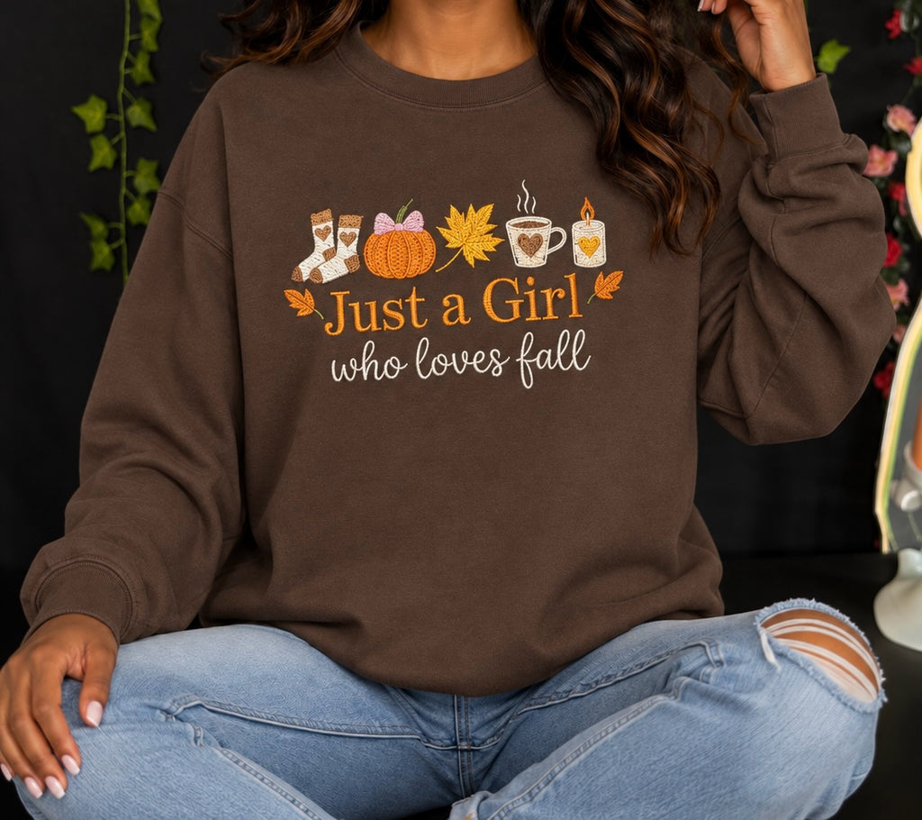Untapped Innovations brown crewneck sweatshirt featuring a Just a Girl Who Loves Fall graphic with autumn motifs.