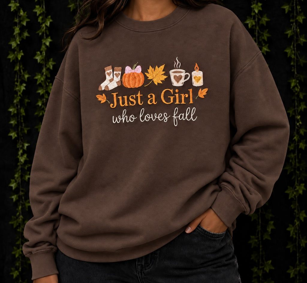 Untapped Innovations brown crewneck sweatshirt with Just a Girl Who Loves Fall graphic featuring autumn motifs.