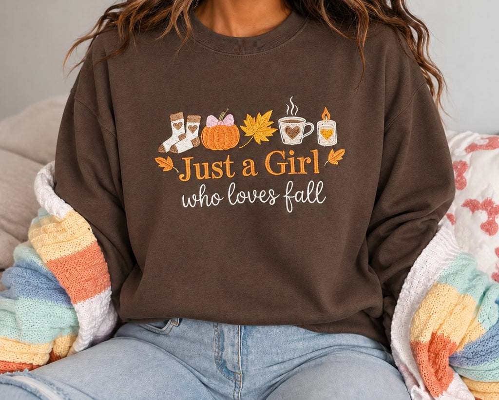 Untapped Innovations brown crewneck sweatshirt featuring a Just a Girl Who Loves Fall graphic with autumn motifs.