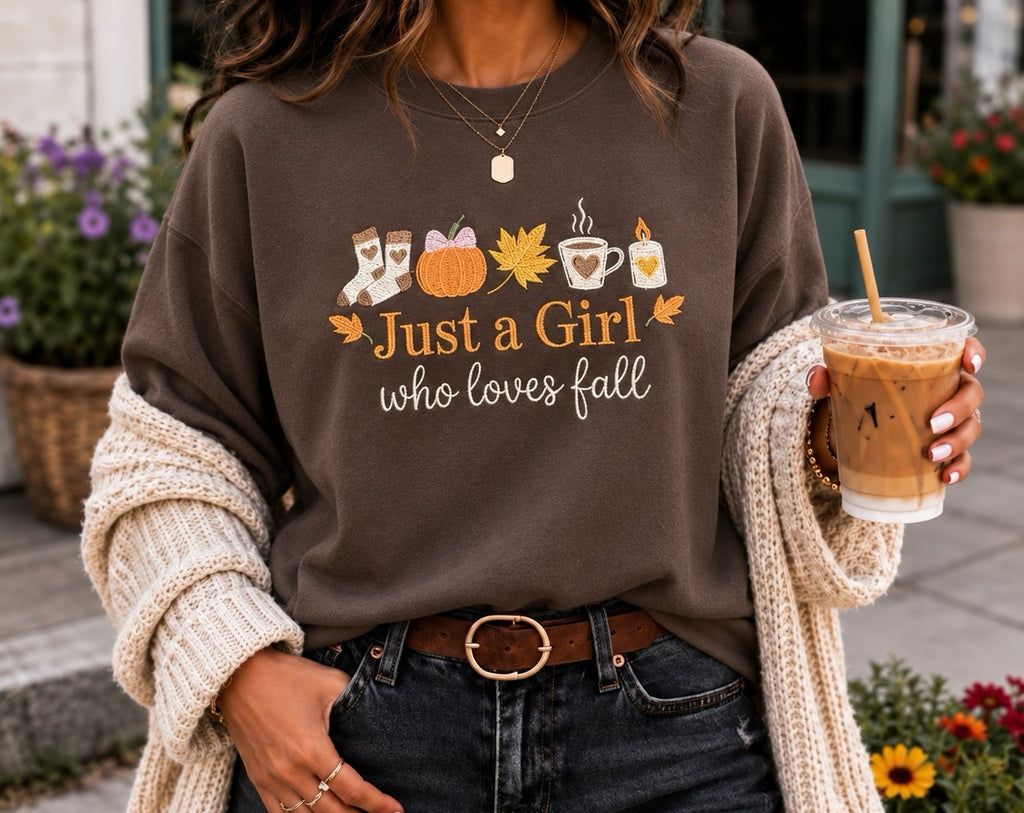 Untapped Innovations dark brown crewneck sweatshirt with Just a Girl Who Loves Fall graphic print and autumn motifs.