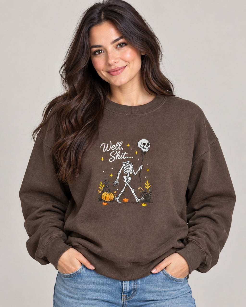 Untapped Innovations chocolate brown crewneck sweatshirt featuring a skeleton graphic with a balloon and pumpkins.