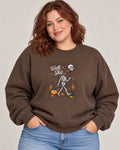 Untapped Innovations chocolate brown crewneck sweatshirt featuring a skeleton graphic with a balloon and pumpkins.