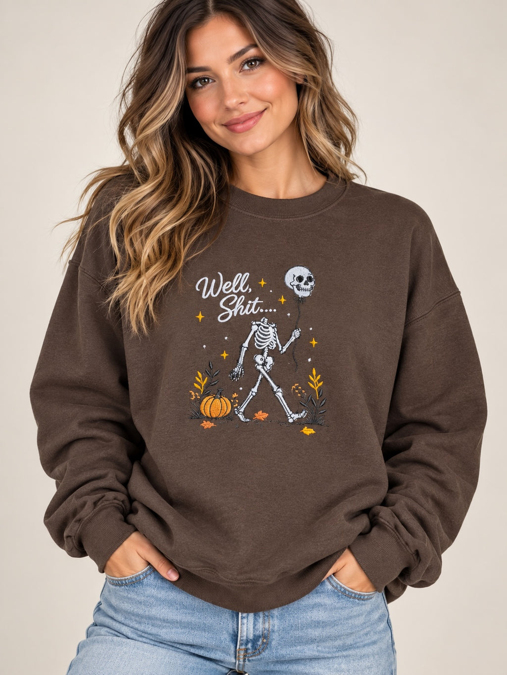 Untapped Innovations chocolate brown crewneck sweatshirt featuring a skeleton graphic with a balloon and pumpkins.