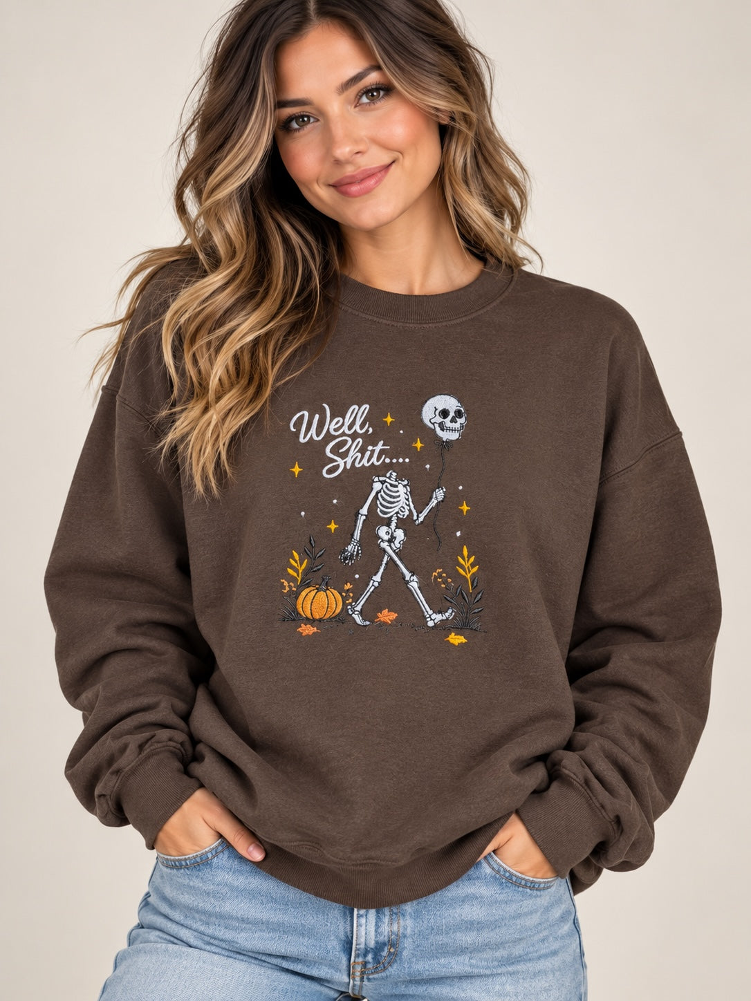 Untapped Innovations chocolate brown crewneck sweatshirt featuring a skeleton graphic with a balloon and pumpkins.