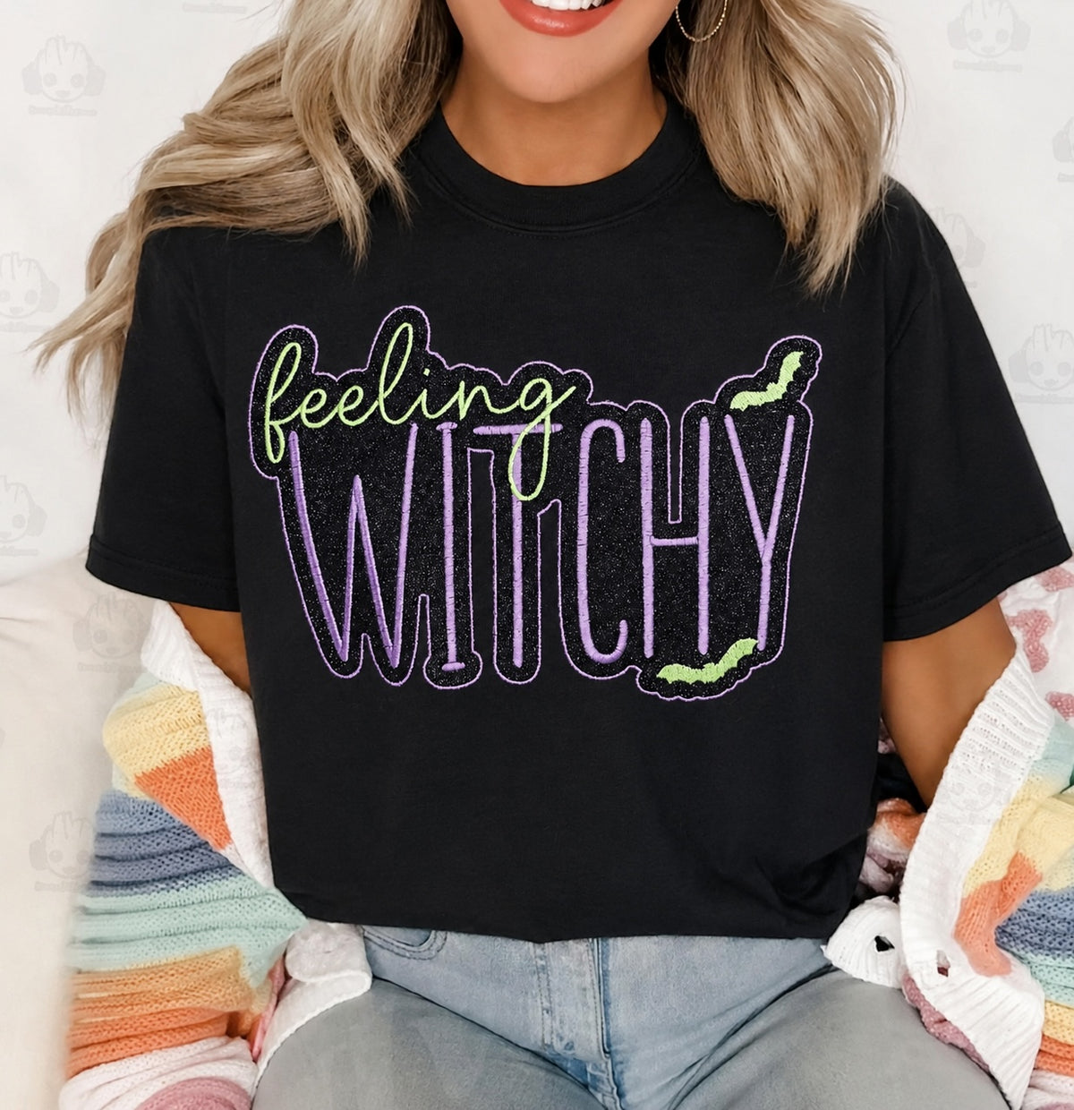 Untapped Innovations black crewneck t-shirt with Feeling Witchy glitter graphic, purple and neon green bat accents.