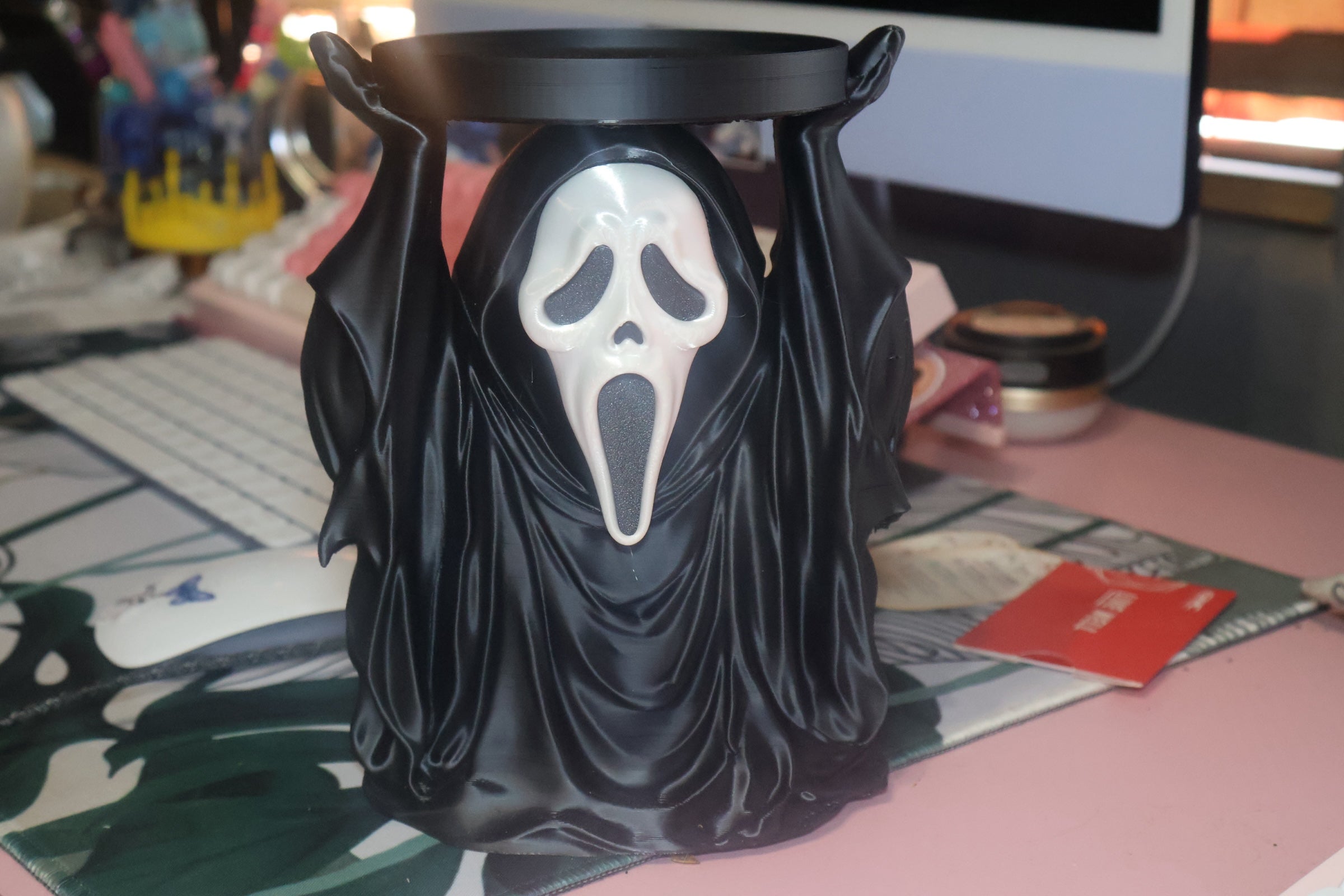 Untapped Innovations horror-themed ghost figure candle holder with a black robe and iconic white mask design.