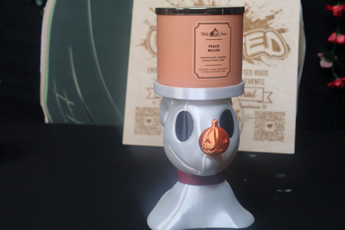 Untapped Innovations ghost dog candle holder with a pearlescent white finish and a glossy orange pumpkin nose.
