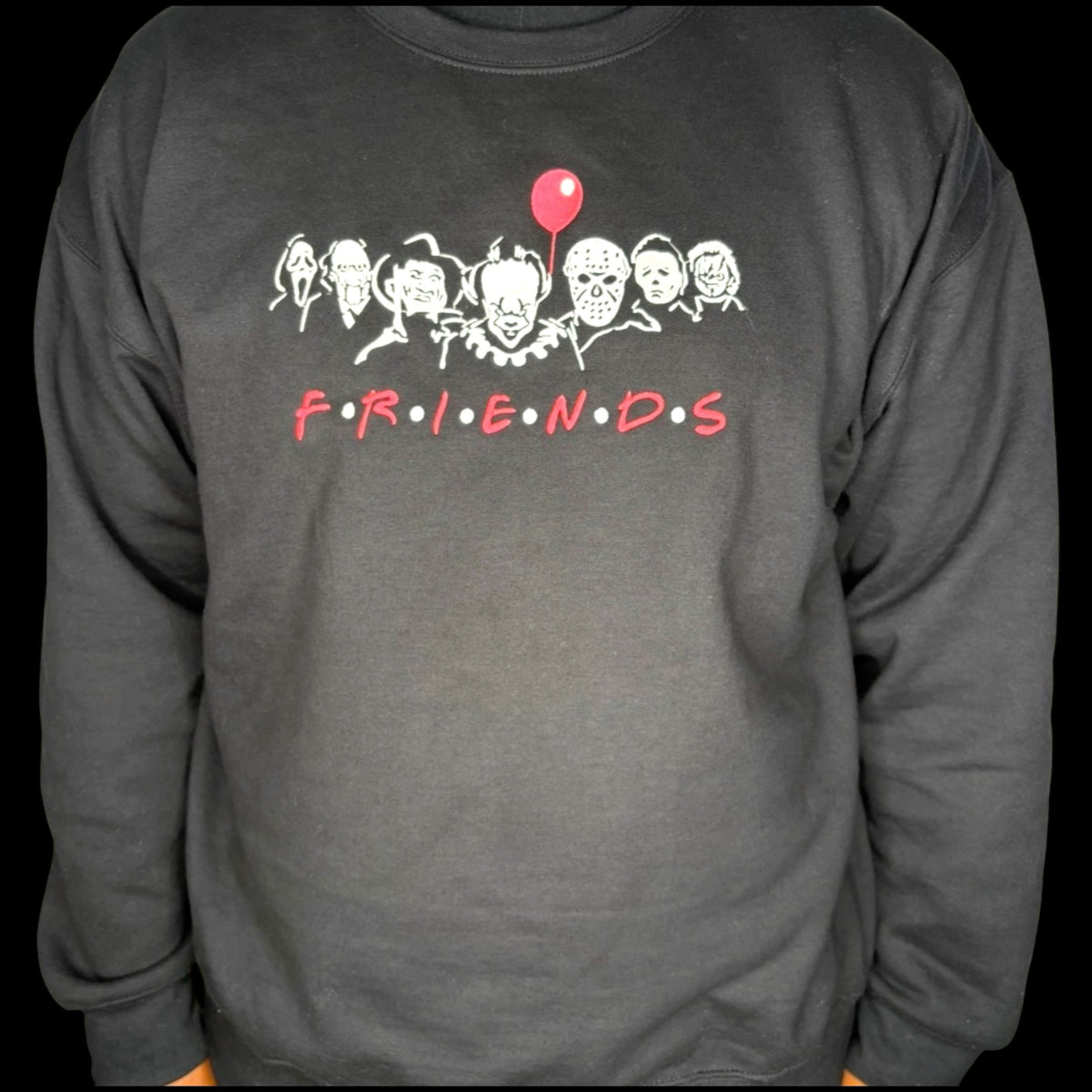 Untapped Innovations black crewneck sweatshirt featuring a horror movie character graphic print with a red balloon.