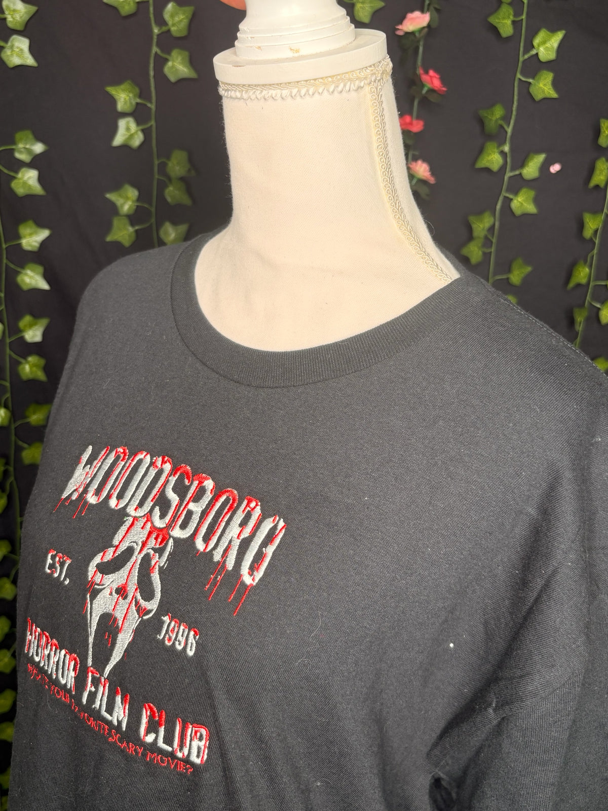 Untapped Innovations black crewneck t-shirt with embroidered Woodsboro Horror Film Club graphic and slasher mask.